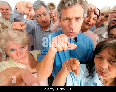 A group of people pointing their fingers in accusation Stock Photo