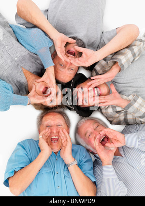 five people lying on the floor and yelling Stock Photo