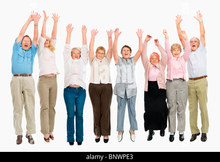 A group of people jumping with their arms raised Stock Photo