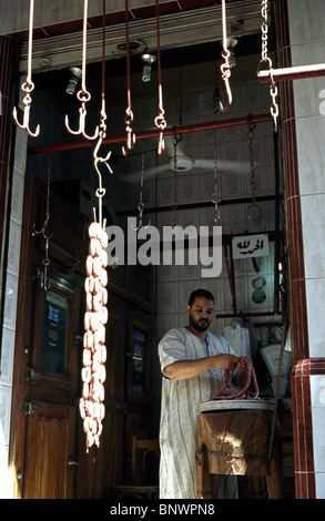 Local butcher making sausages by hand in the souks of Alexandria in Egypt. Stock Photo