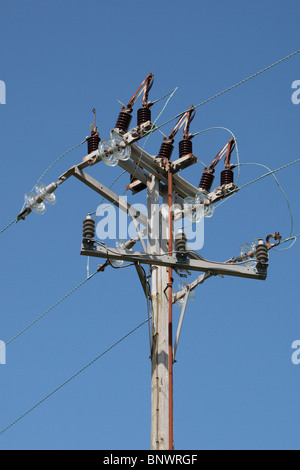 A power line (wires/cables) on a wooden telegraph pole on the edge of a field near Bridport, Dorset, UK. Stock Photo