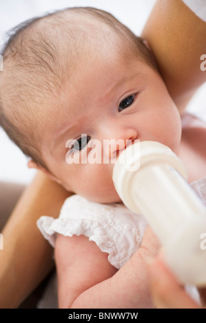 Mother feeding her baby a bottle Stock Photo