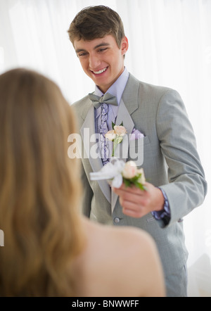 Man giving corsage to woman Stock Photo