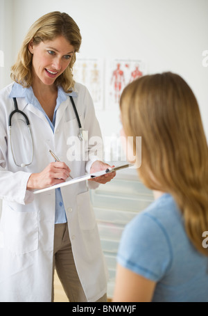 Doctor talking to patient in exam room Stock Photo