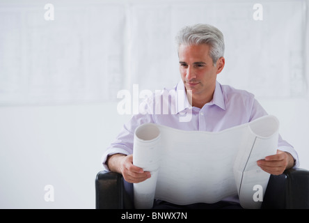 Architect looking at house plans Stock Photo
