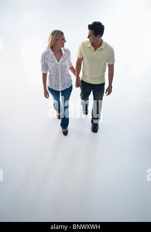 Happy couple walking hand in hand Stock Photo