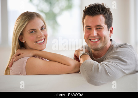 Happy couple relaxing on couch Stock Photo