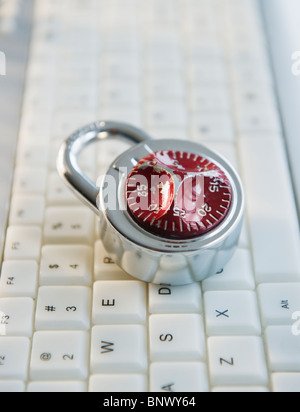 Combination lock on top of keyboard Stock Photo