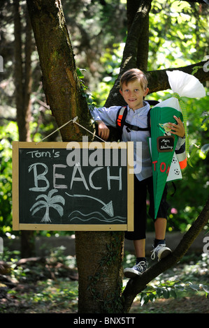 First day at school. Boy with cardboard cone in the schoolyard. Stock Photo