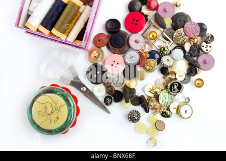 sewing stuff buttons nails thread scissors mixed still life on white Stock Photo