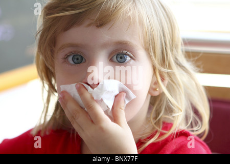 little blond girl tissue in nose Stock Photo