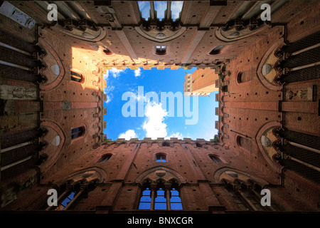 View from courtyard up towards the Torre del Mangia tower in Siena, Italy Stock Photo