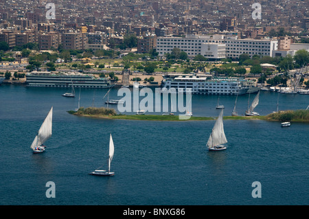 feluccas and cruise ships sailing on the Nile River in Aswan Egypt Stock Photo