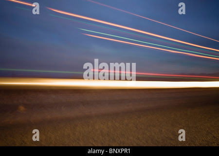 Light trails along highway Stock Photo