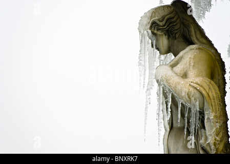 Statue of female figure, face obscured by icicles Stock Photo