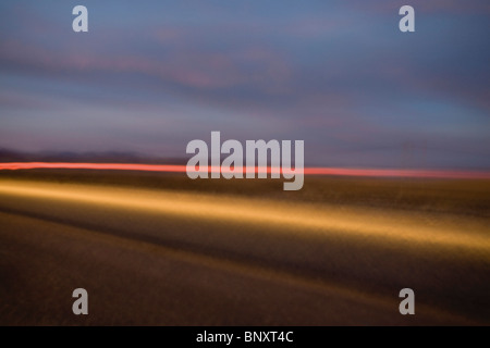 Light trails along highway Stock Photo
