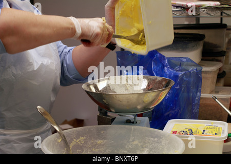 Making scones - adding butter/fat to the mixture Stock Photo