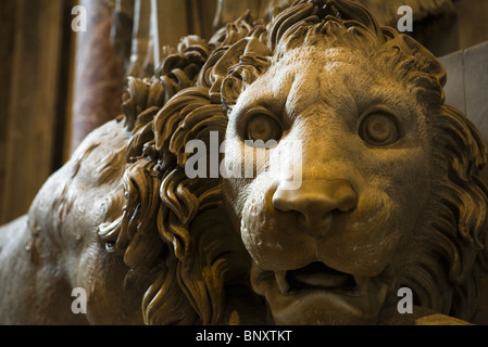 Statue of vigilant lion flanking Monument to Pope Clement XIII, St. Peter's Basilica, Rome, Italy Stock Photo