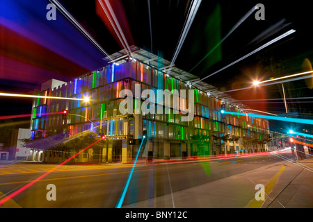 Streaked Light From a Colorful Lit Parking Garage at Night Stock Photo