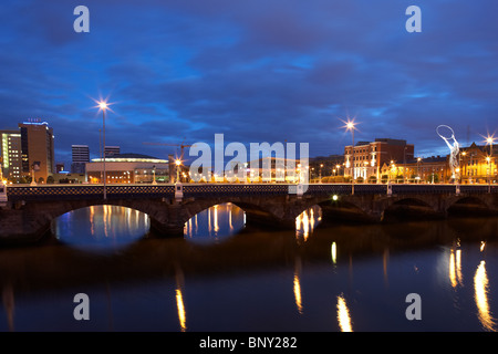 the queens bridge river lagan and laganside waterfront at night in Belfast Northern Ireland UK Stock Photo