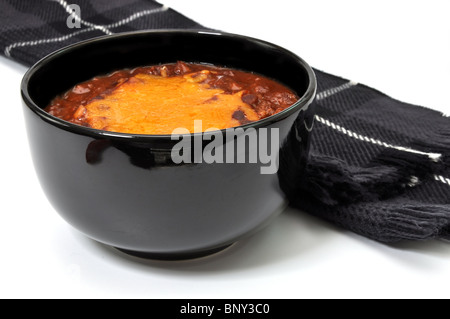 Bowl of chili with melted cheese and scarf isolated on white background. Stock Photo