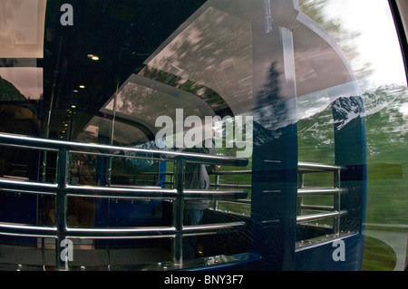 Tourist looks through the large viewing windows on an Alaska Railroad Coastal  Classic Train Stock Photo