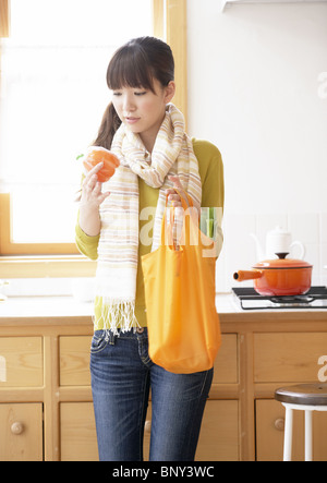 Young woman holding a bell pepper Stock Photo