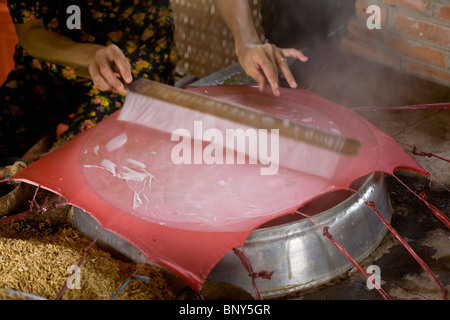 Steaming a sheet of rice paper Stock Photo