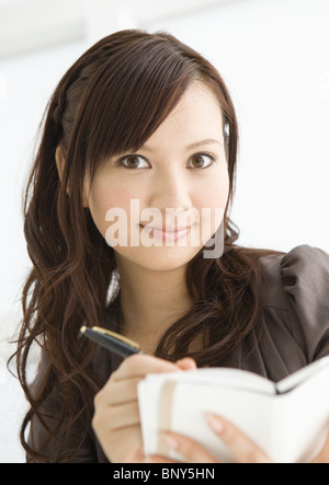 Business woman taking notes Stock Photo