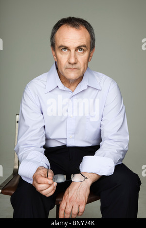 Mature man looking up in thought Stock Photo