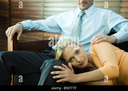 Woman resting her head on man's lap Stock Photo