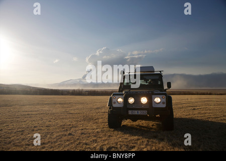 Land Rover Defender 90 300TDI in front of Eyjafjallajokull Volcan erupting in the background Stock Photo