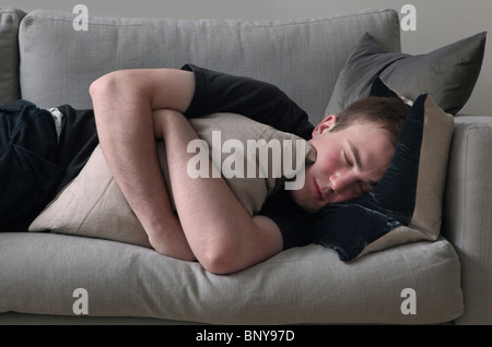 Man sleeping on sofa Stock Photo