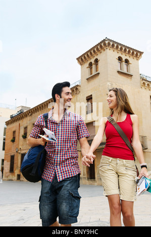 Couple holding hands in old city square Stock Photo