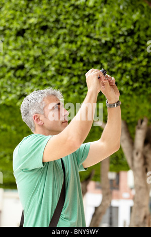 Man taking picture with camera Stock Photo