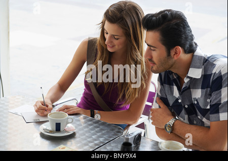 Young woman writing postcards Stock Photo