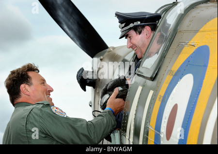 Steve Ricards of the Luftwaffe Reinactment Group climbs into a Spitfire in the Battle of Britain village helped by Dave Hobson ( Stock Photo