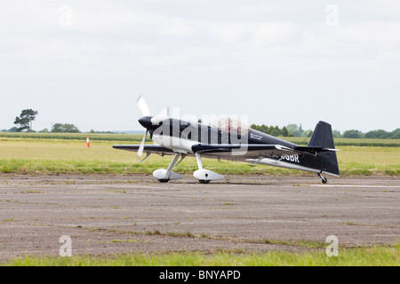 Avions Mundry CAP232 G-OGBR  with Gerald Cooper at the controls taxiing along the runway at Wickenby Airfield Stock Photo