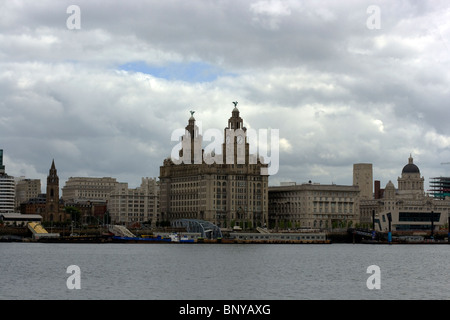 Liverpool waterfront skyline from the Mersey Ferry showing the three graces and the landing stage Stock Photo