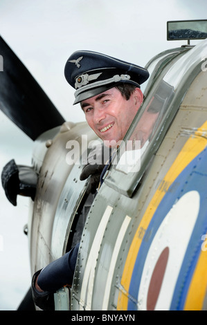 Steve Ricards of the Luftwaffe Reinactment Group appears to have hijacked a Spitfire in the Battle of Britain village at The Roy Stock Photo