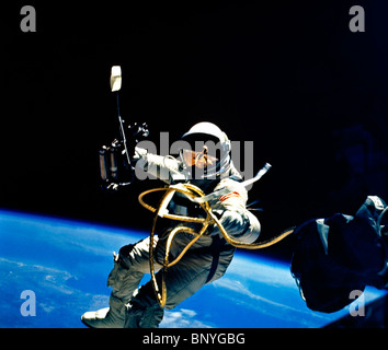 Astronaut Ed White the First American to Conduct a Spacewalk on Gemini 4 Mission June 3rd 1965 - Manuevering gun in his Right hand and Tether Cable Stock Photo