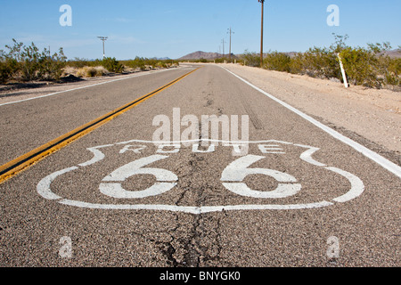 A stretch of old Route 66 with the highway logo still painted on the road. Stock Photo