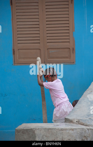 Cape Verde Islands, Sao Vicente. Coastal village of Salamansa. Young girl doing laundry. Stock Photo