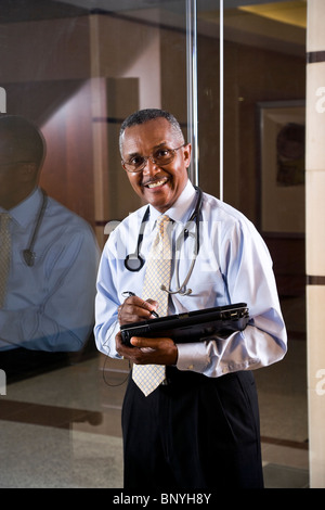 Middle-aged African American doctor holding laptop Stock Photo