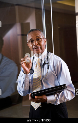 Middle-aged African American doctor holding laptop Stock Photo