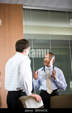 Multiracial doctors conversing in office Stock Photo