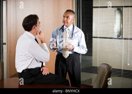 Multiracial doctors conversing in office Stock Photo