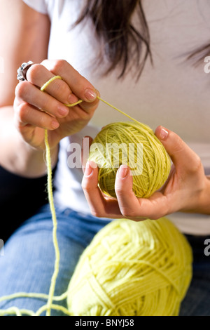 Cropped view of woman winding ball of yarn Stock Photo