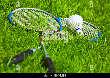 Badminton rackets on green grass. Stock Photo