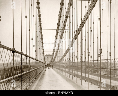 Menai Suspension Bridge over the Menai Strait in its original form with a wooden road surface, c. 1880 Stock Photo